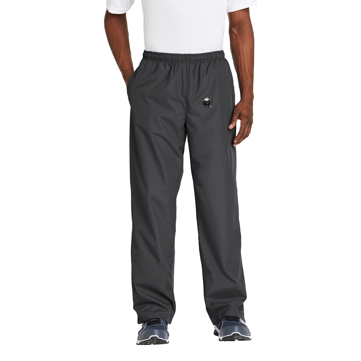 Black Square Golf Wind Pants in Graphite, front view on model with Black Square mascot logo on the left thigh